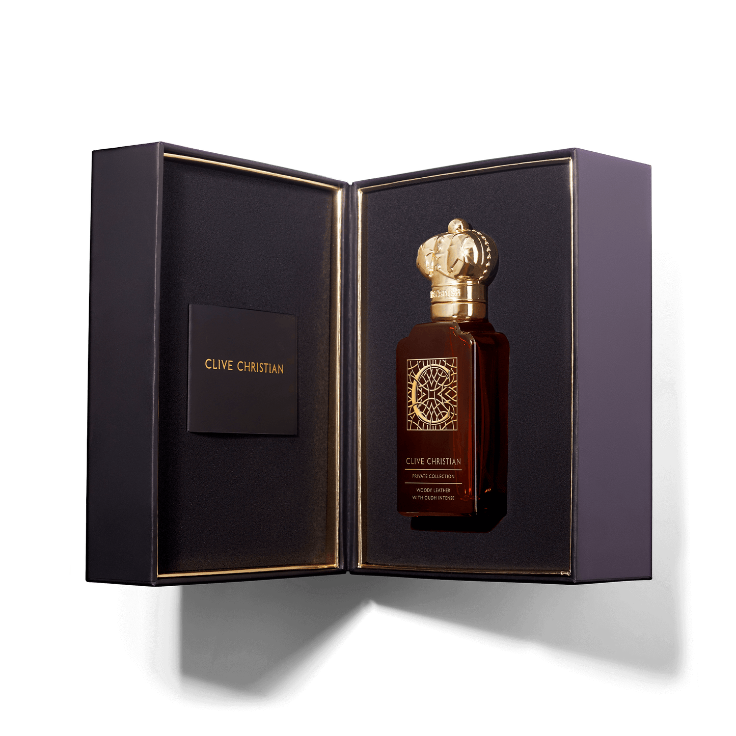 Open presentation box reveals a Clive Christian Woody Leather with Oud Intense perfume bottle featuring a gold crown cap.